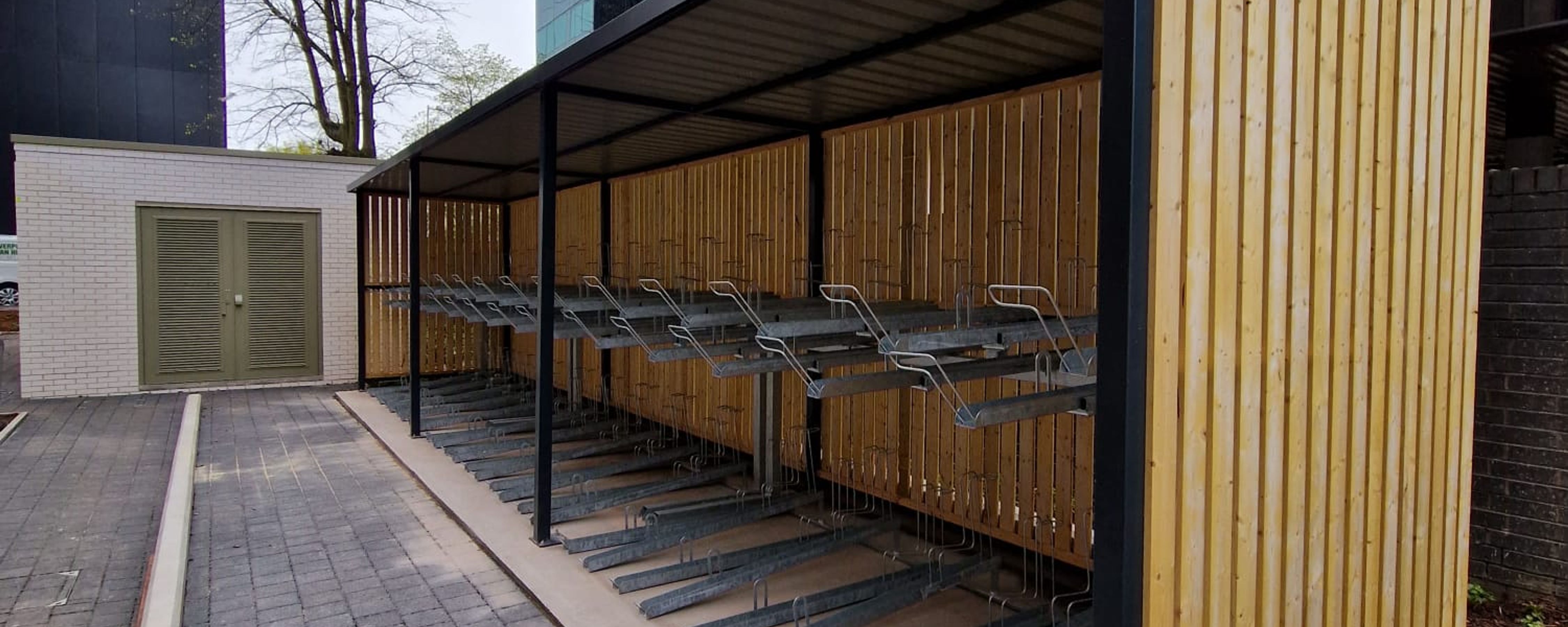 Fabricated Steel Bike Shelter With Vertical Racks in Mesh Cage Finish
