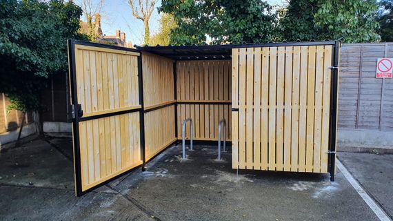 8 Space timber clad cycle shelter one gate open.jpg