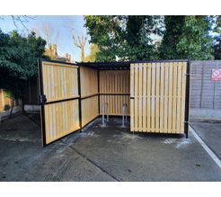 8 Space timber clad cycle shelter one gate open.jpg