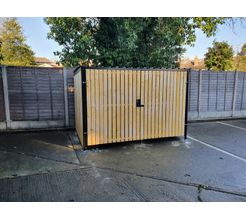 8 Space timber clad cycle shelter front gate closed.jpg