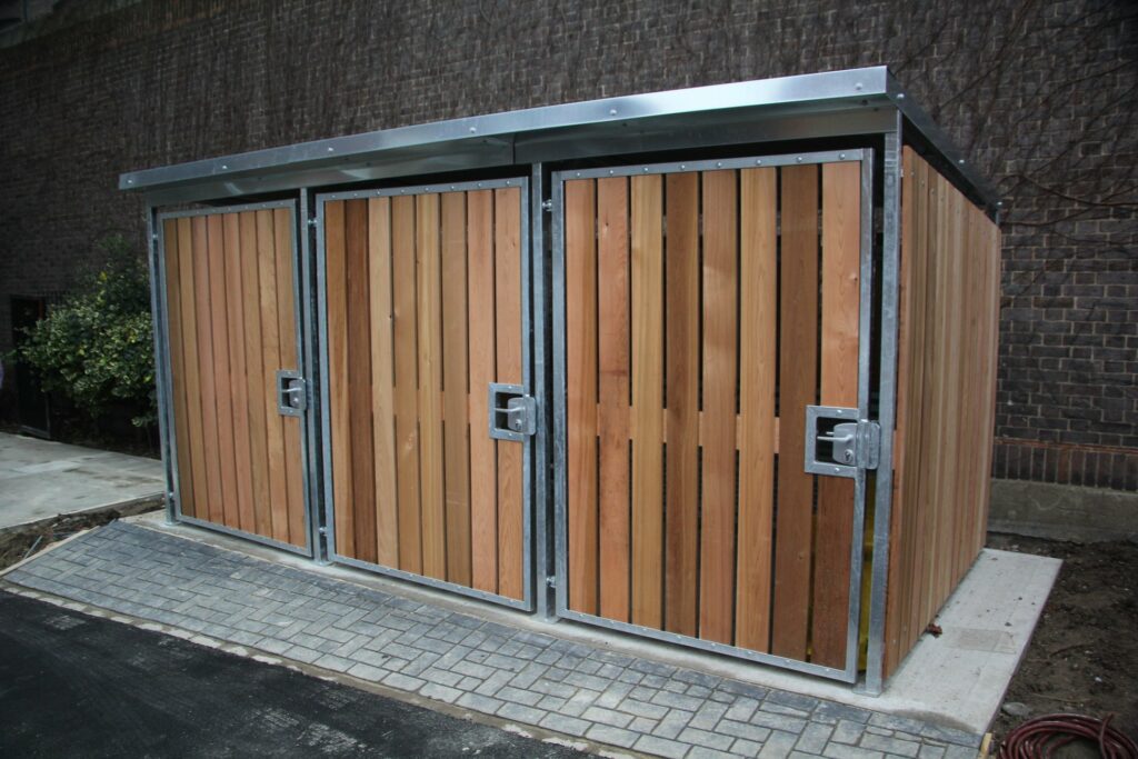 Bespoke timber clad bike shelter with 3 timber clad single swing gates.
