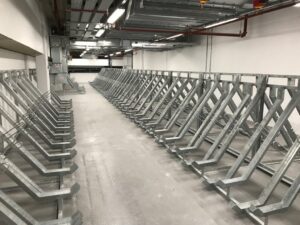 Semi-vertical bike racks in London, newly installed in the basement area after being securely bolted to the ground.