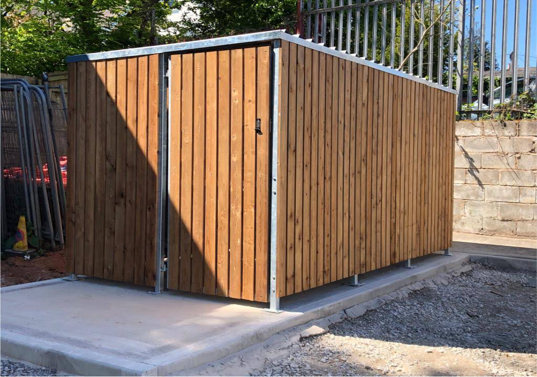 Newly installed, bespoke timber clad bike shelter, housing 10 bike spaces with Semi-vertical bike Racks. Delivered and assembled for Hamilton Church in this outdoor location.