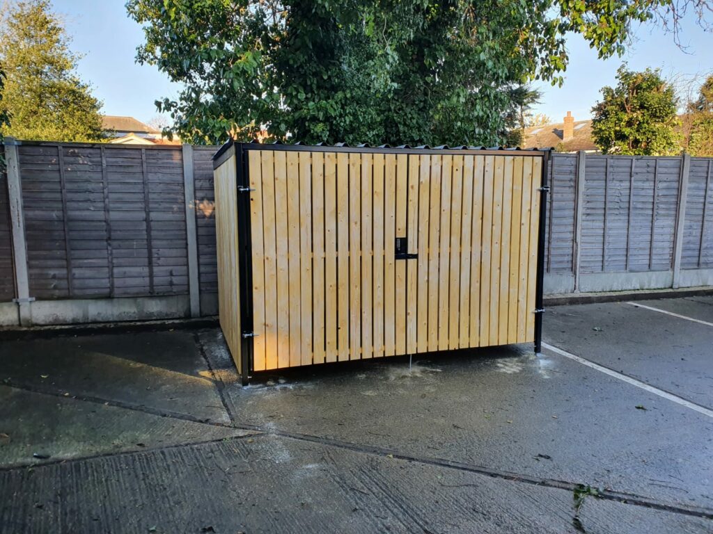 Secure Cycle Store's newly installed timber clad bike shelter, with timber clad swing gates and digital combination lock. This shelter is outdoors and is housing 4 Sheffield bike stands. This successful project was for 4 walls yard.