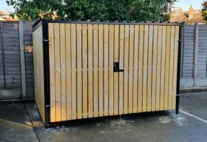 Secure Cycle Store's newly installed timber clad bike shelter, with timber clad swing gates and digital combination lock. This shelter is outdoors and is housing 4 Sheffield bike stands. This successful project was for Riverside Industrial Estate.