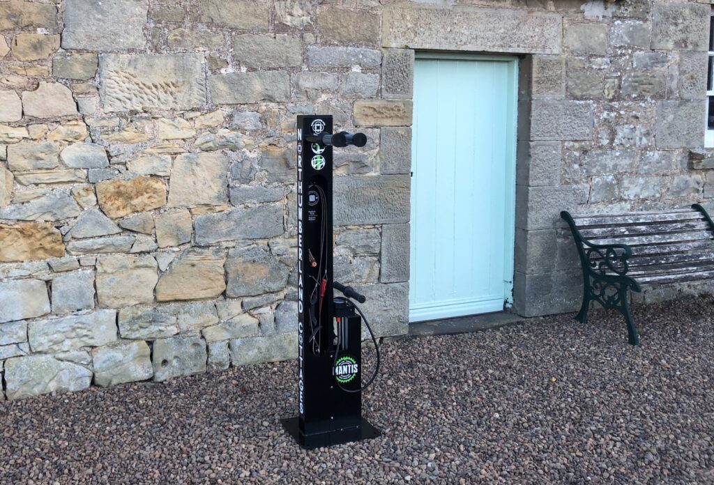 Northumberland Cottages newly installed Mantis Bike Repair Stand, with custom branding. Located outdoors and ready for its intended use.