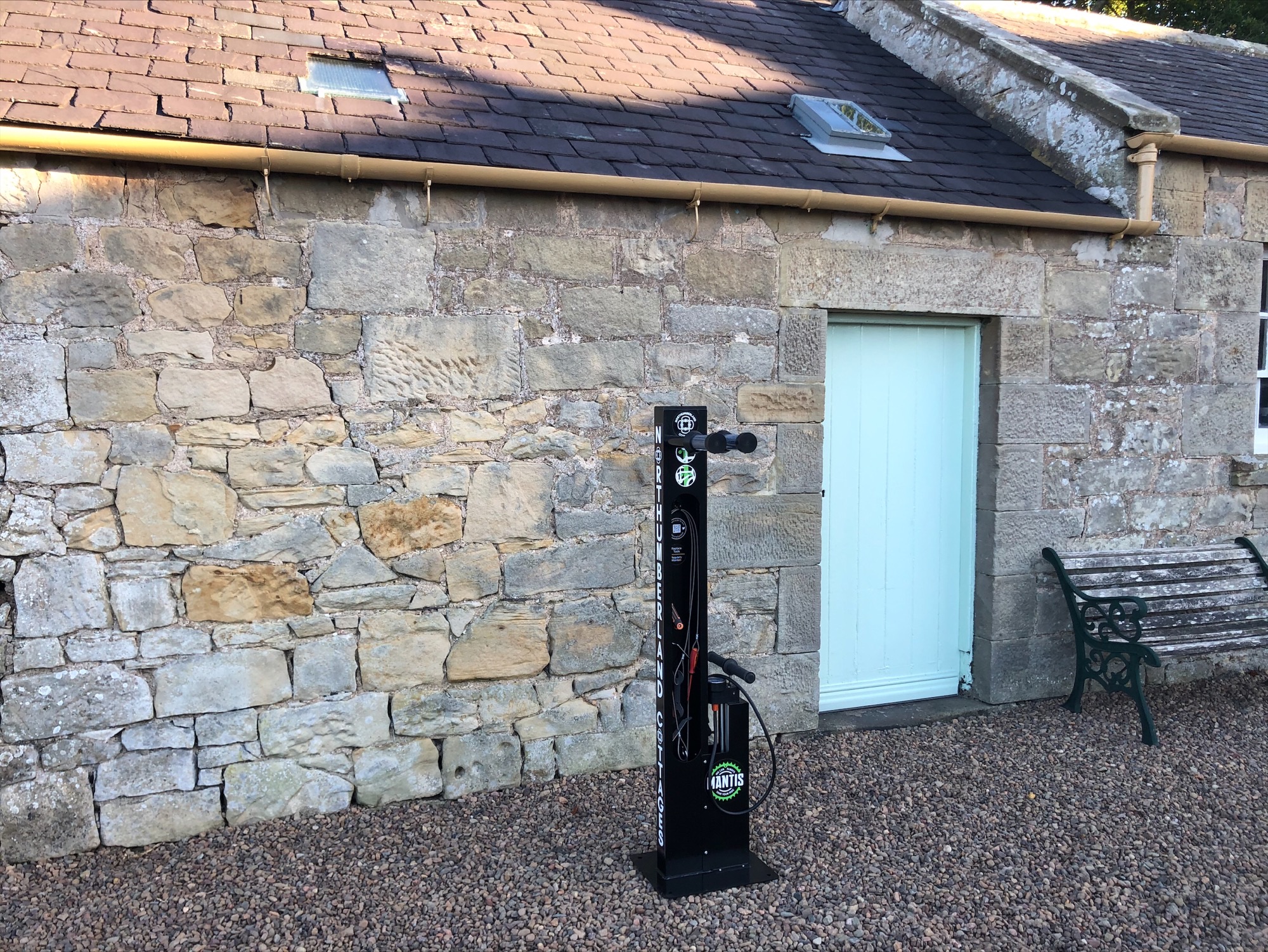 Northumberland Cottages newly installed Mantis Bike Repair Stand, with custom branding. Located outdoors and ready for its intended use.