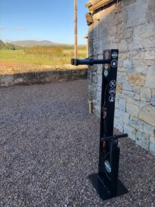 Northumberland Cottages newly installed Mantis Bike Repair Stand, with custom branding. Located outdoors and ready for its intended use.
