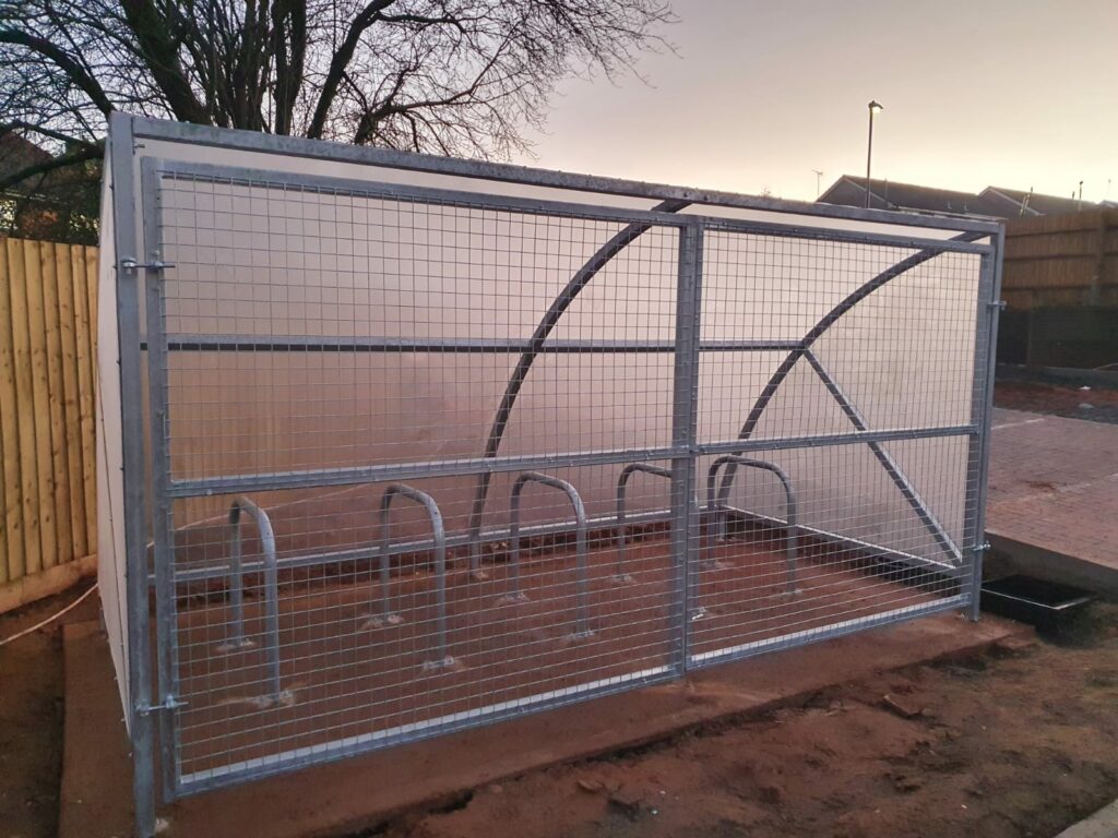 Secure Cycle Store's newly installed Canal Curved Bike Shelter on Musketeer Avon Road. Outdoors for residential use.