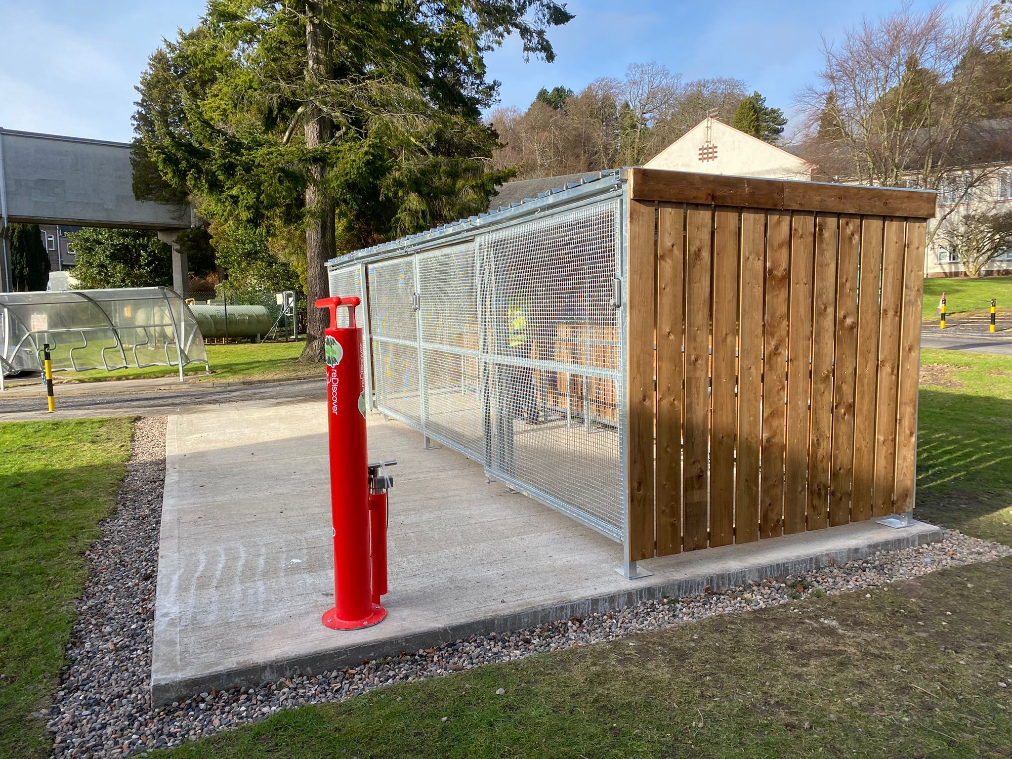 Secure Cycle Store's Trinity timber bike shelter, installed outdoors for the public and staff of NHS Royal Victoria hospital.