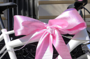 close-up of a brand new bike with pink bow attached.
