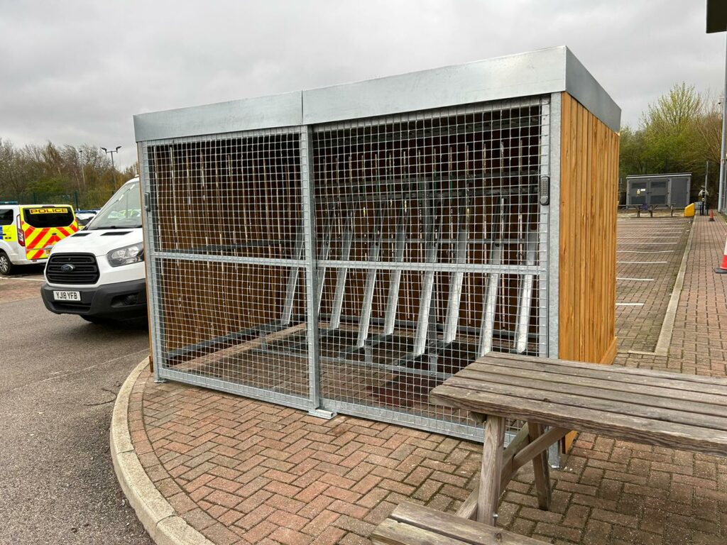 Wooden bike shelter with sliding mesh gate
