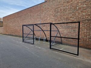 10 space Canal Curved Cycle Storage Shelter installation. A secure gated design, galvanised steel frame. A durable solution for secure cycle storage across commercial, workplace and public locations. 