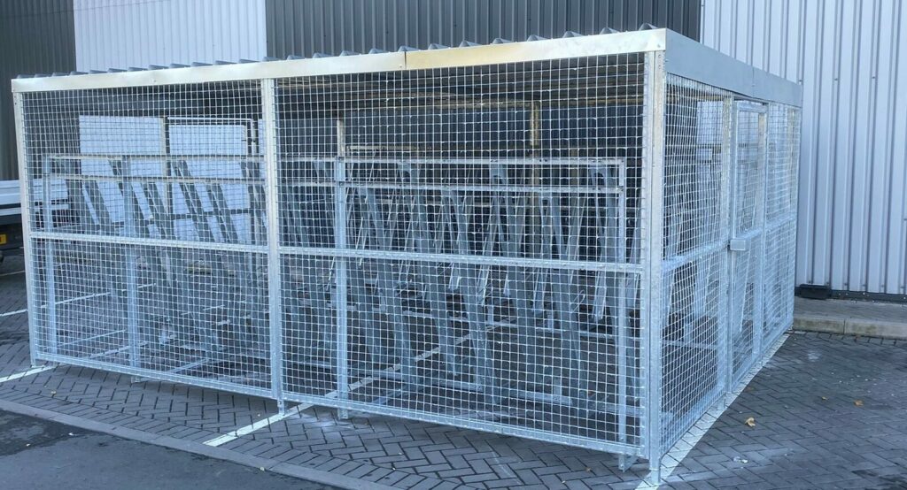 newly installed merton mesh bike shelter, located outdoors behind the hello fresh bin.