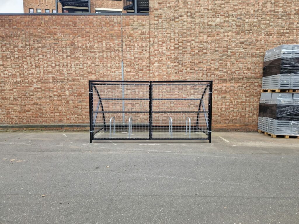 10 space Canal Curved Cycle Storage Shelter installation. A secure gated design, galvanised steel frame. A durable solution for secure cycle storage across commercial, workplace and public locations. 