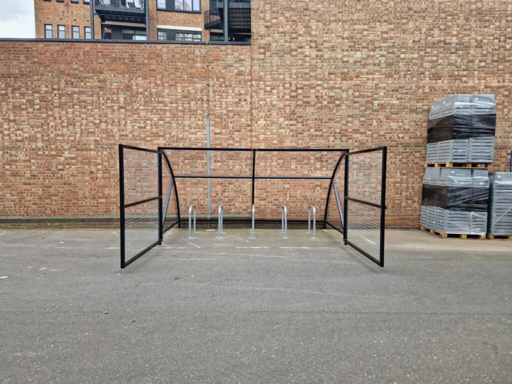 10 space Canal Curved Cycle Storage Shelter installation. A secure gated design, galvanised steel frame. A durable solution for secure cycle storage across commercial, workplace and public locations. 