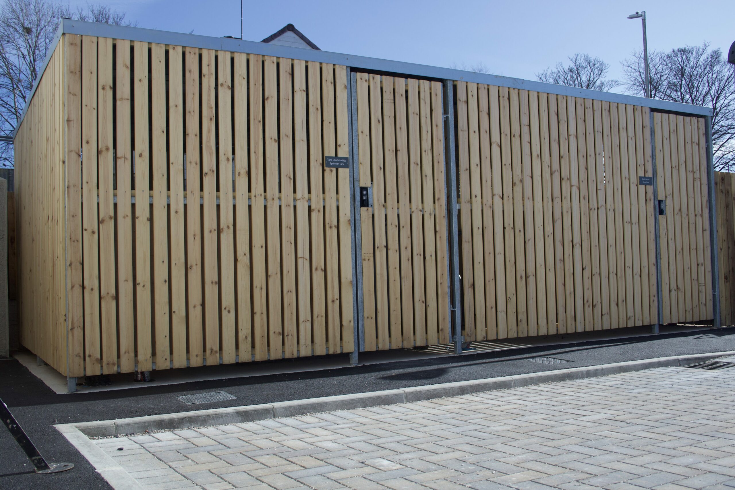 Full designed and installed bike shelter with single doors and digital combination locks