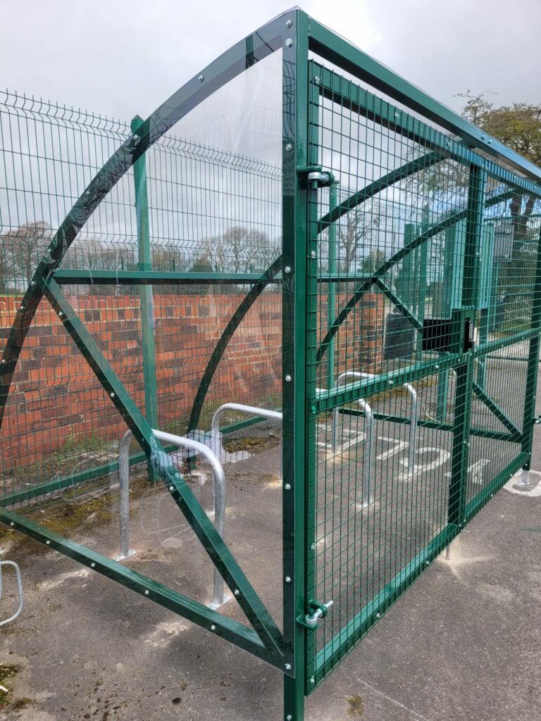 Installation featuring galvanised steel frame, PETG cladding and Sheffield stands for 8 bikes. Durable, weather-resistant, secure solution.