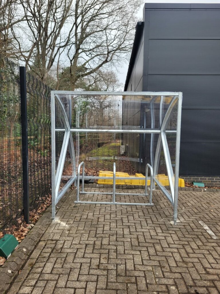 single cycle shelter with steel frame and plastic exterior. open fronted design for easy access 