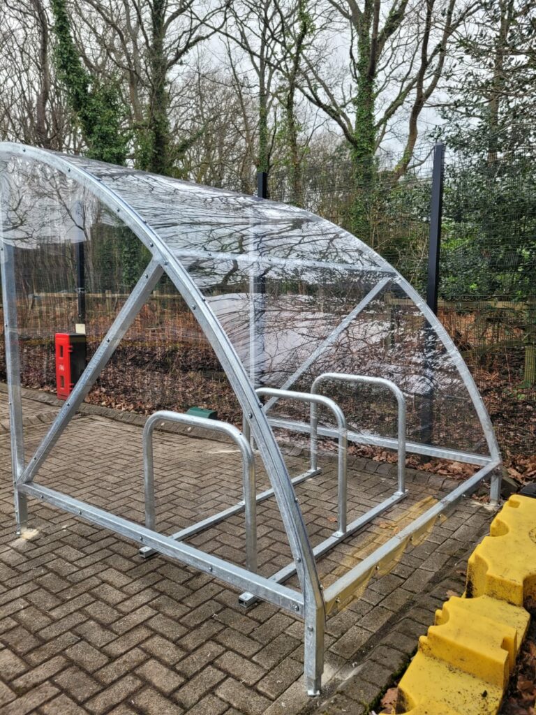 single cycle shelter with steel frame and plastic exterior. open fronted design for easy access 