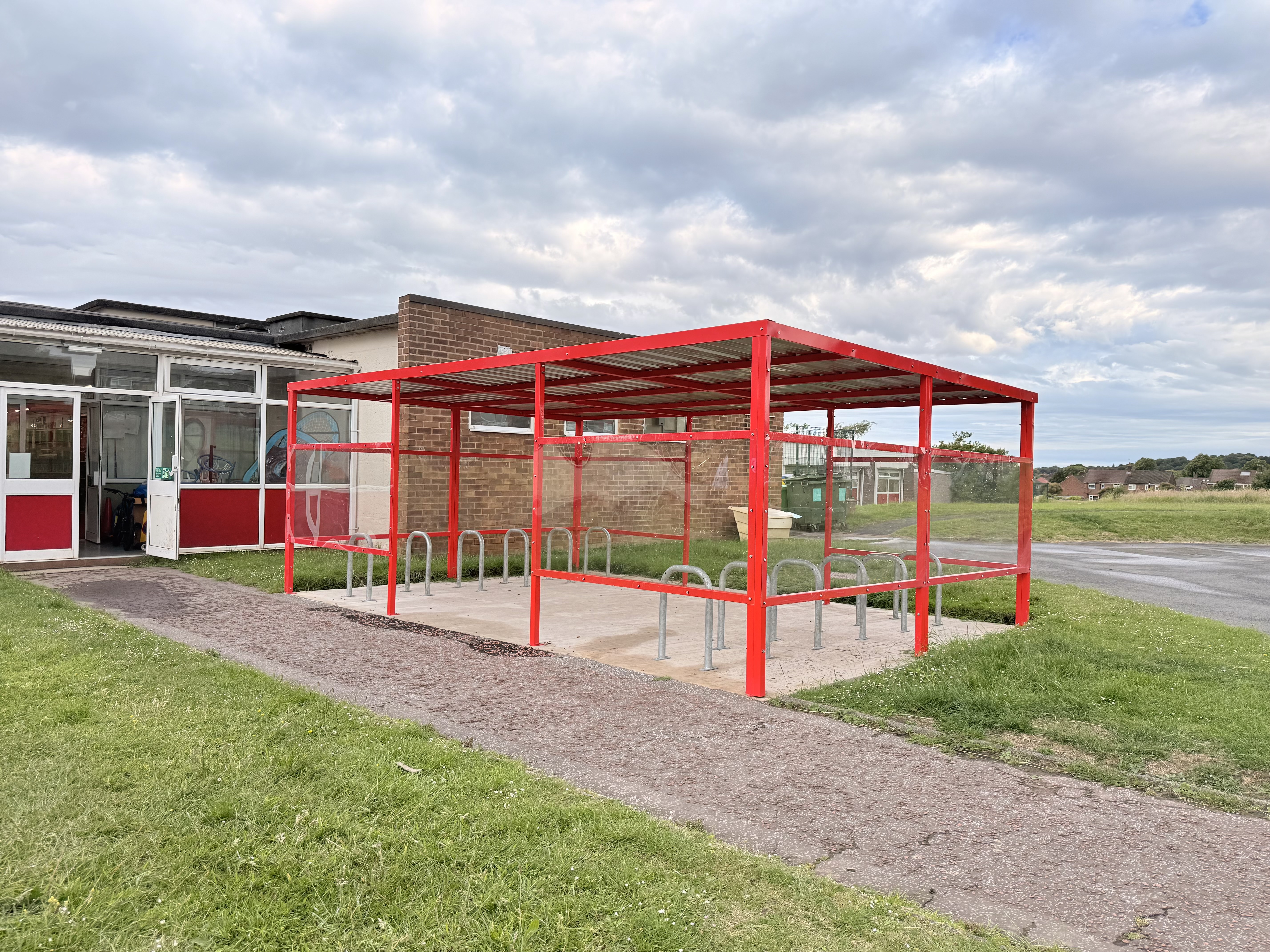 The shelter features a galvanised box profile steel roof,